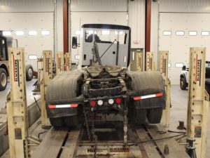 Semi truck on Blackhawk Powercage frame correction machine